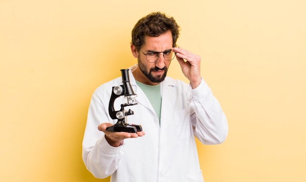 Young man scientist with microscope concept