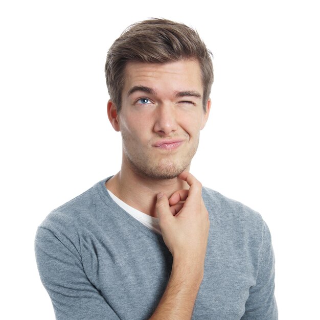 Young man scratching his head