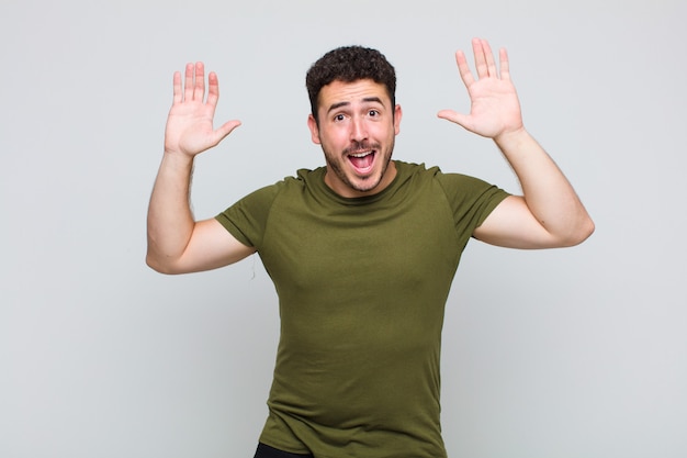 Young man screaming in panic or anger, shocked, terrified or furious, with hands next to head