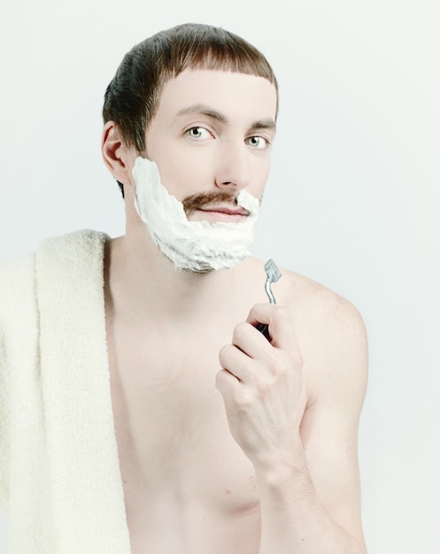 Young man shaving