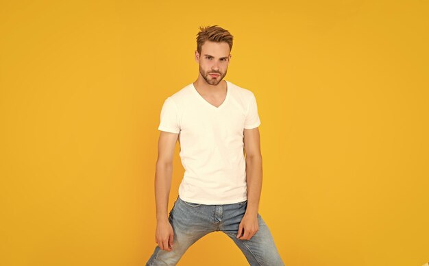 Young man in shirt on yellow background lifestyle