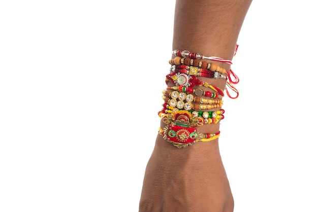 Young man showing rakhi on his hand on an occasion of Raksha Bandhan festival.