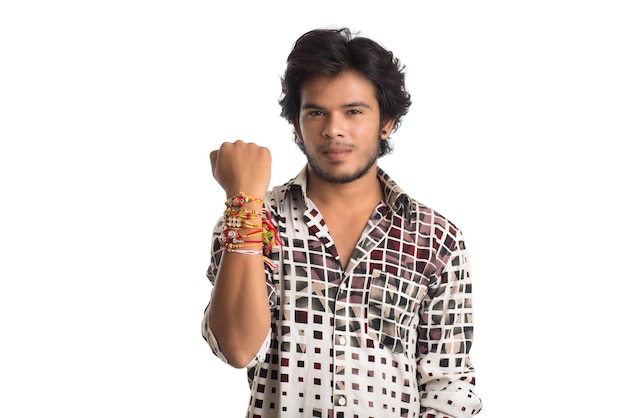 Young man showing rakhi on his hand on an occasion of Raksha Bandhan festival.