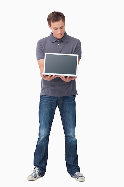Молодой человек, показывая экран своего ноутбука