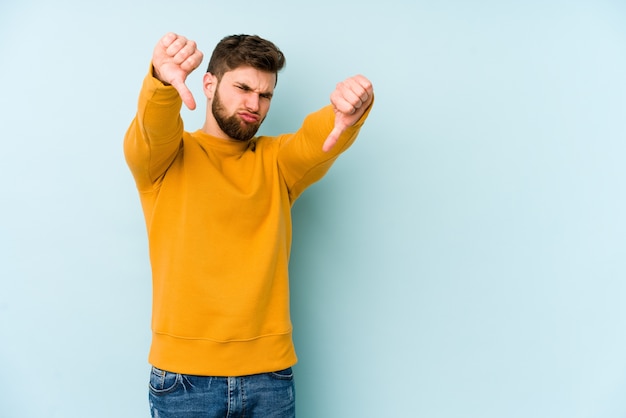 Young man showing thumb down