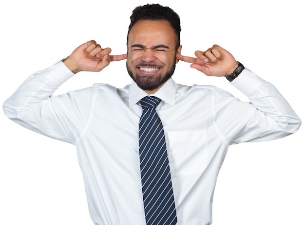 Young man shows he does not want to hear . Fingers in his ears