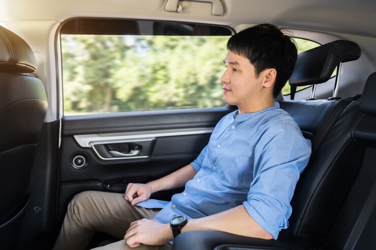 https://img.freepik.com/premium-photo/young-man-sitting-back-seat-car_35076-5237.jpg?w=740