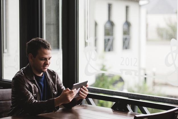 Young man sitting in a cafe during