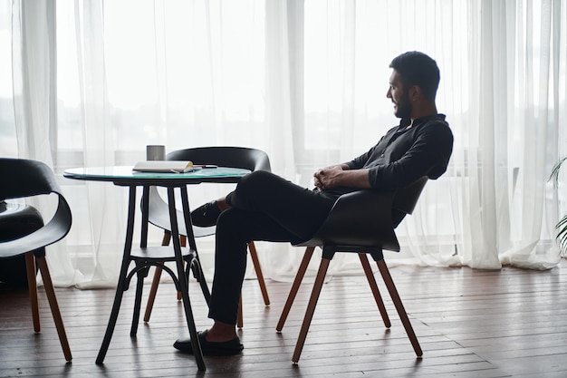 Young man sitting at a coffee table