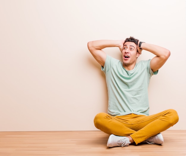 Young man sitting on the floor