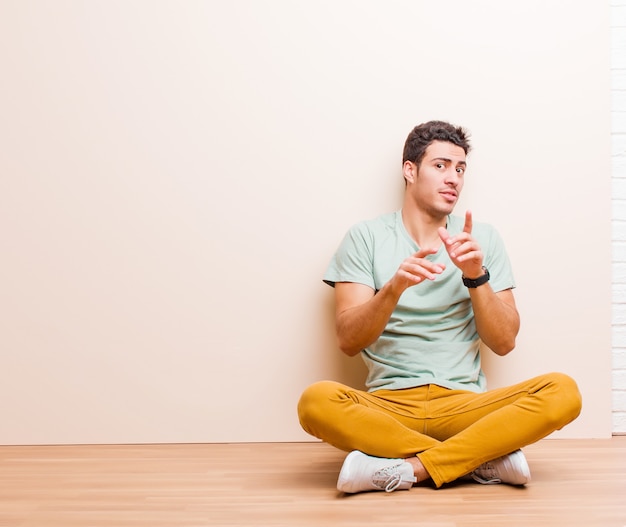 Young man sitting on the floor