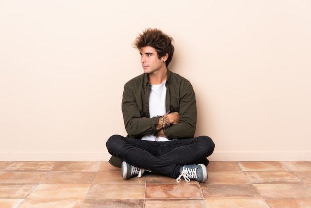 Photo young man sitting on the floor