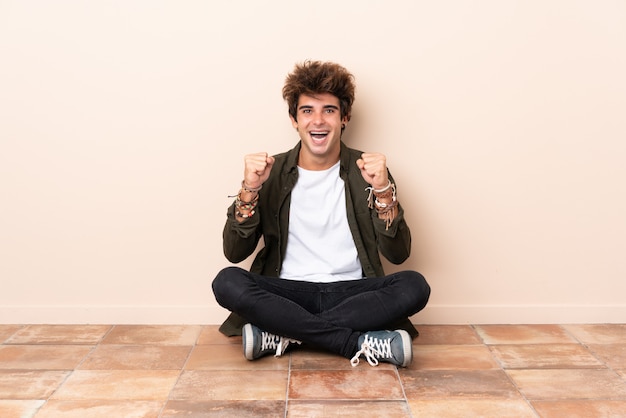 Young man sitting on the floor