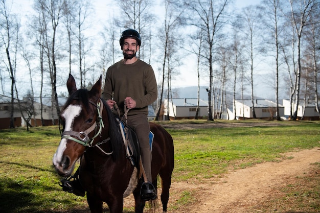 Young Man Sitting on a Horse Outdoors