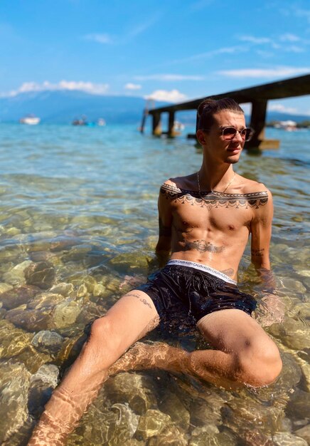 Young man sitting in sea