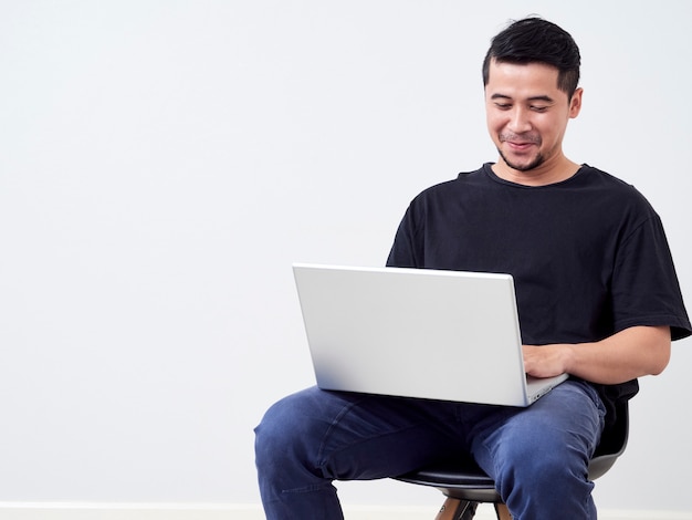 Young man sitting work with laptop