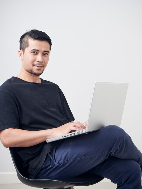 Young man sitting work with laptop