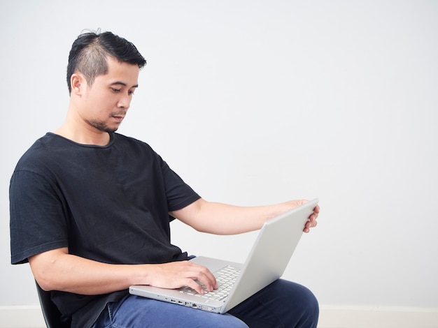 Young man sitting work with laptop