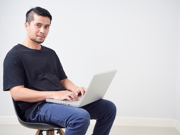 Young man sitting work with laptop