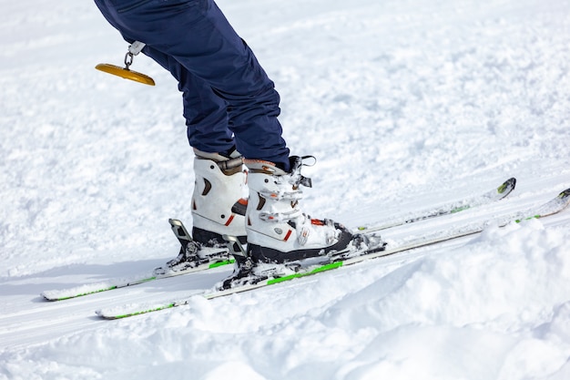 Young man on skis out of slopes, Equipment and extreme winter sports at place for skiing