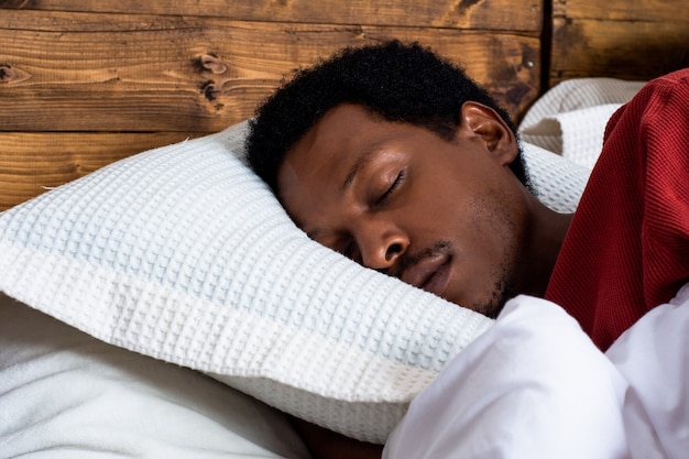 Young man sleeping in bed