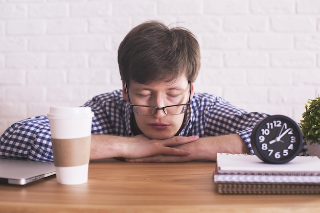 Young man sleeping in office