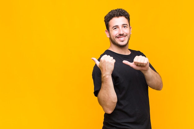 Young man smiling and casually pointing