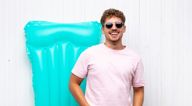 Young man smiling cheerfully and casually with a positive isolated