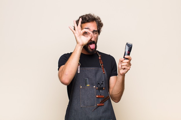 Young man smiling, feeling confident, successful and happy, showing concept or idea on copy space on the side