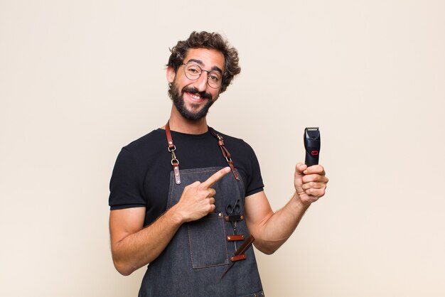 Young man smiling happily and pointing to side