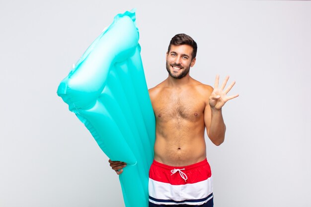 Young man smiling and looking friendly isolated