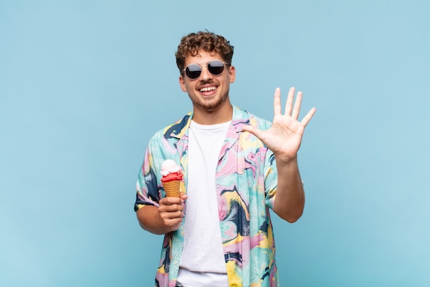 Young man smiling and looking friendly isolated