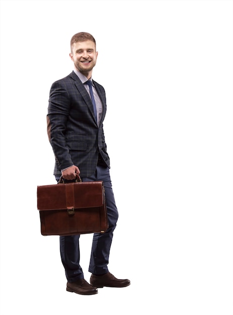 Young man smiling in a suit with a briefcase in his hands