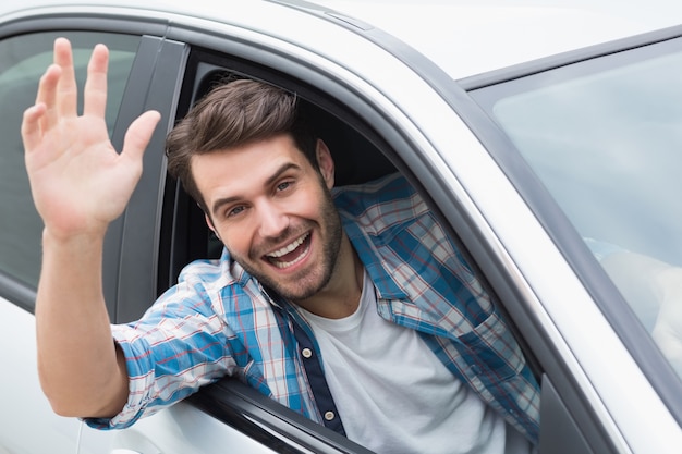 Young man smiling and waving