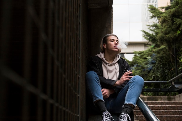 Young man smoking cigarette