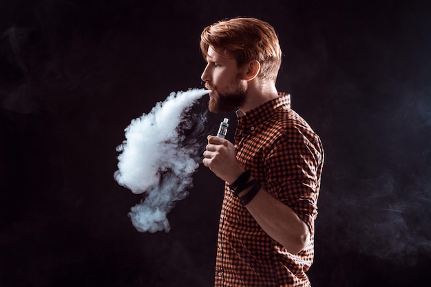 Young man smoking electronic cigarette