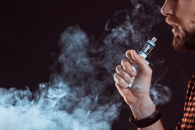 Young man smoking electronic cigarette