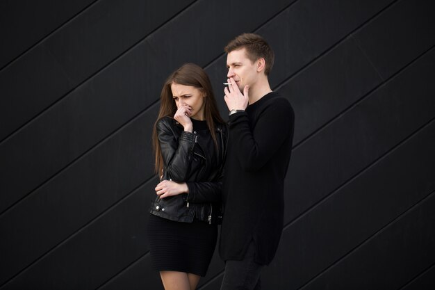 Young man smoking near his lover