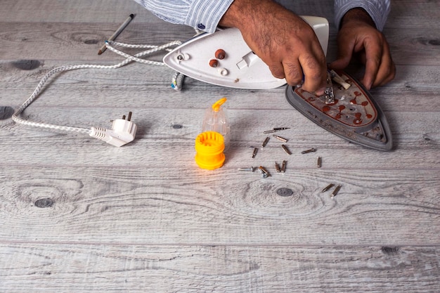 Young man soldering home work on the table