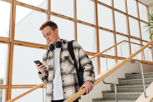 Young man standing against wall