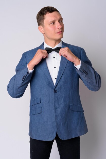 Young man standing against white background