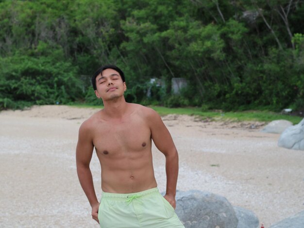 Young man standing on beach