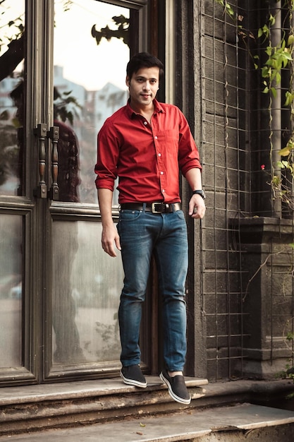 Young man standing at entrance door