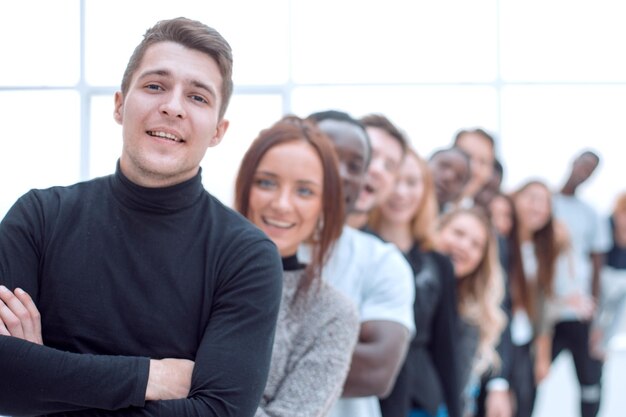 Young man standing in front of a group of young people