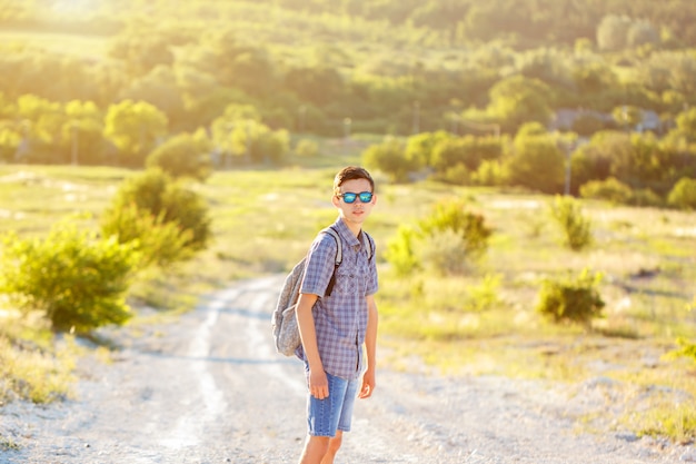 a young man standing on the road