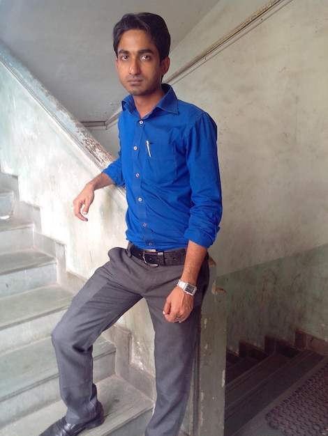 Young man standing in staircase