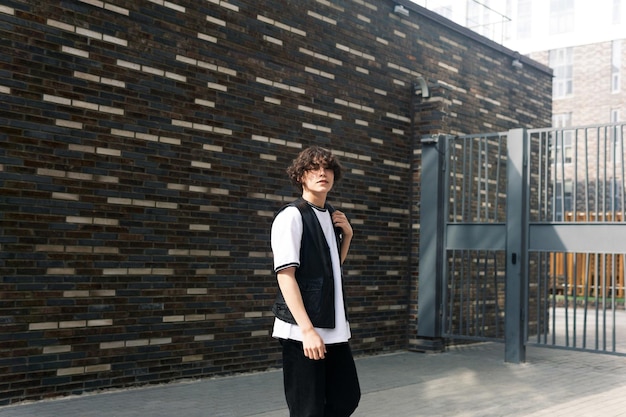 Young man on the street against the urban landscape