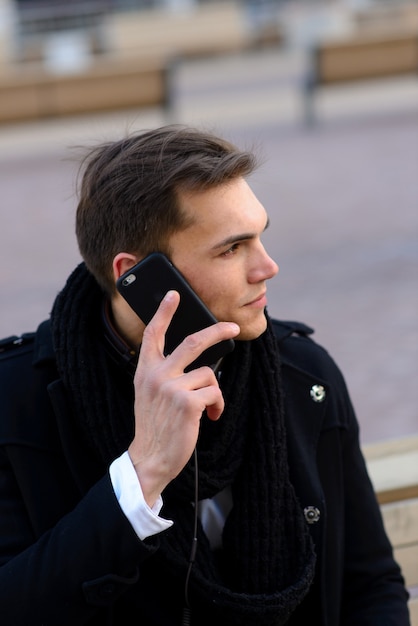 Young man on the street with mobile phone