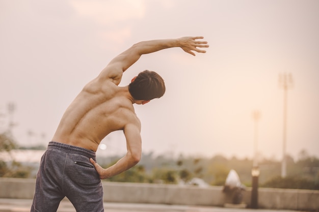 Young man stretching outdoors