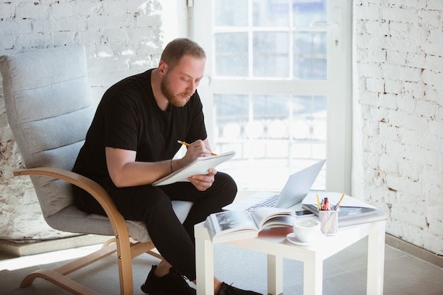 Young man studying at home during online courses for teacher medical service manager